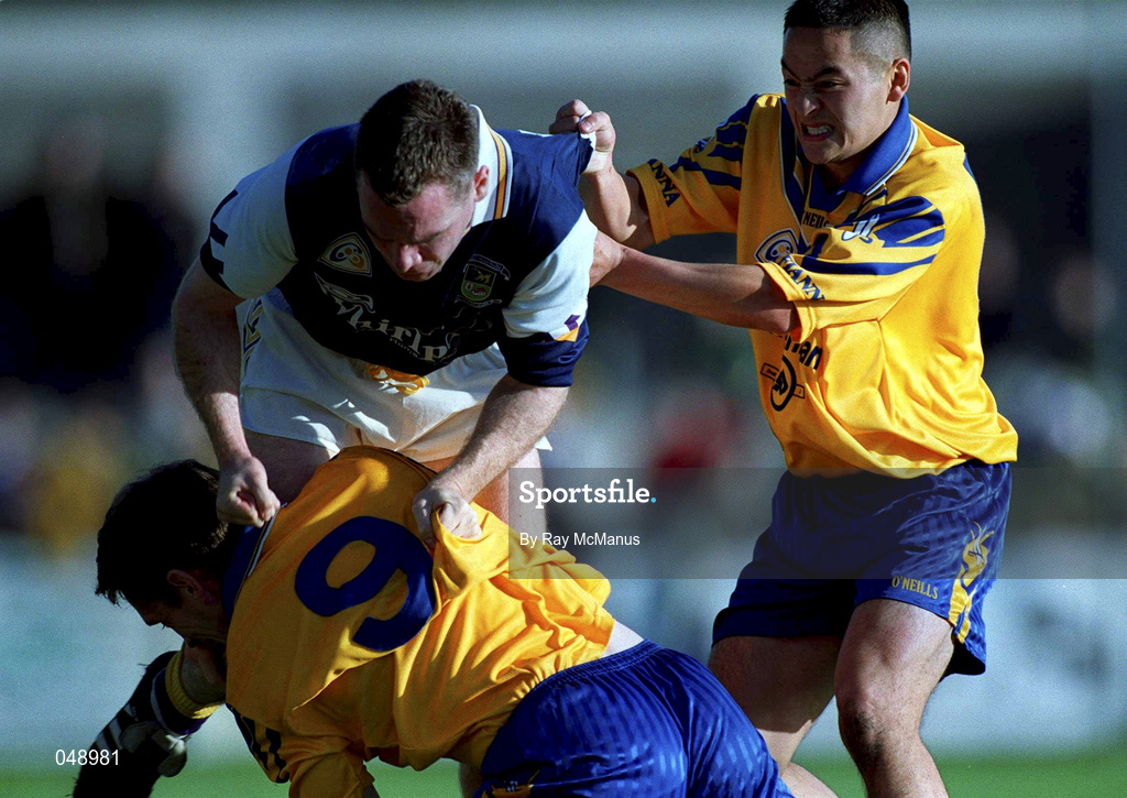 14 October 2000; Nigel Clancy of Kilmacud Crokes tussles with Kieran McGeeney, left, and Jason Sherlock of Na Fianna during the Evening Herald Dublin Senior Football Championship Final match between Na Fianna and Kilmacud Crokes at Parnell Park in Dublin. Photo by Ray McManus/Sportsfile