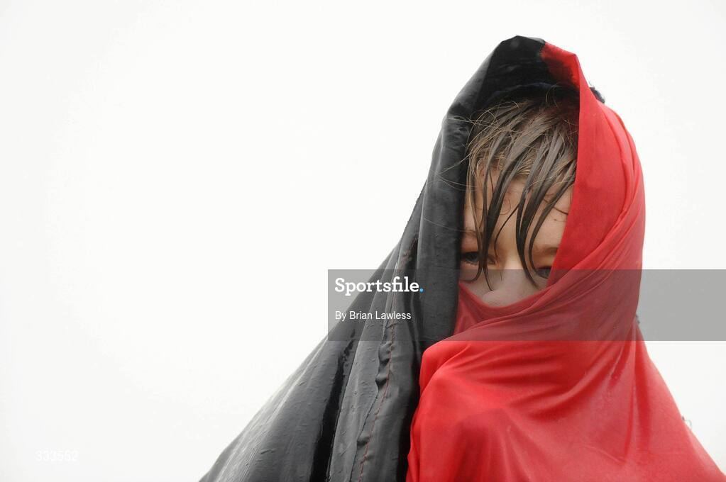 14 January 2009; Wesley College supporter Daniel Kelly uses his flag to shelter from the rain during the match. Leinster Schools Vinnie Murray Senior Cup First Round - Section B, Newpark v Wesley College, Kiltiernan, Co. Dublin. Picture credit: Brian Lawless / SPORTSFILE
