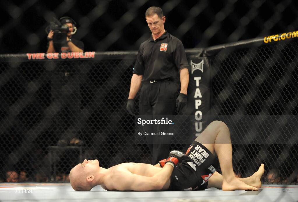 17 January 2009; Martin "The Hitman" Kampmann lies on the canvas after receiving a kick to the groin from Alexandre Barros during their welterweight bout. UFC 93, Ultimate Fighting Championship, The O2, Dublin. Picture credit: Diarmuid Greene / SPORTSFILE