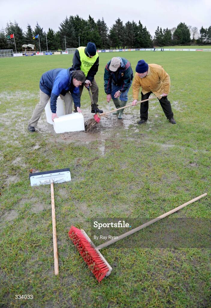 18 January 2009; Stewards try to remove the excess water from the pitch before the match. FBD League, Section A, Mayo v Roscommon, Ballyhaunis GAA Club, Ballyhaunis, Co. Mayo. Picture credit: Ray Ryan / SPORTSFILE