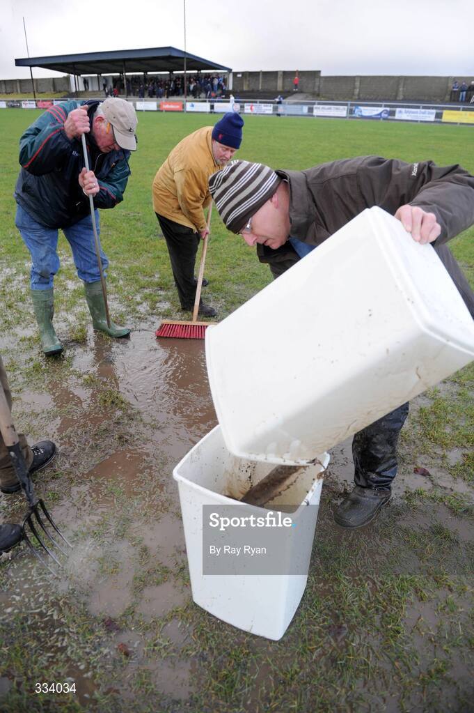18 January 2009; President of Ballyhaunis GAA club Michael Webb, empties excess water from the pitch before the match. FBD League, Section A, Mayo v Roscommon, Ballyhaunis GAA Club, Ballyhaunis, Co. Mayo. Picture credit: Ray Ryan / SPORTSFILE