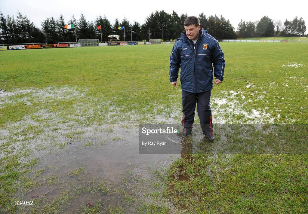 18 January 2009; Mayo manager John O'Mahony inspects the water on the pitch before the match. FBD League, Section A, Mayo v Roscommon, Ballyhaunis GAA Club, Ballyhaunis, Co. Mayo. Picture credit: Ray Ryan / SPORTSFILE
