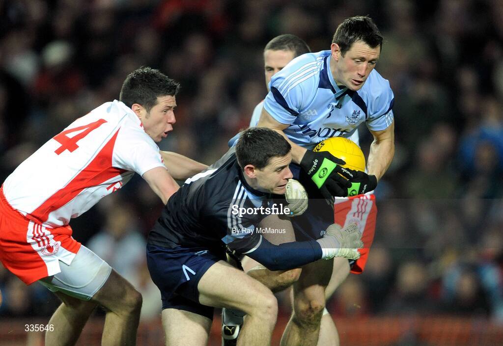 31 January 2009; Dublin full-back Donncha Bastick, supported by keeper Stephen Cluxton, wins possession from Tyrone's Sean Cavanagh. Allianz National Football League, Division 1, Round 1, Dublin v Tyrone, Croke Park, Dublin. Picture credit: Ray McManus / SPORTSFILE