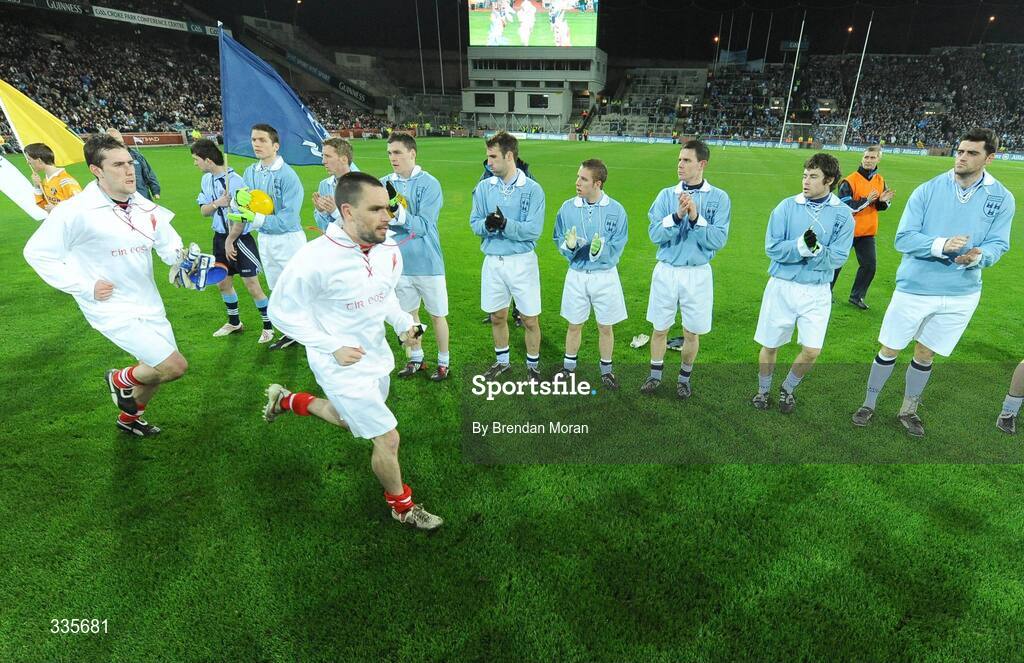31 January 2009; Tyrone captain Ryan McMenamin leads his side out as Dublin stand in a guard of honour, as both sides wear 'retro playing kit', before the game. Allianz National Football League, Division 1, Round 1, Dublin v Tyrone, Croke Park, Dublin. Picture credit: Brendan Moran / SPORTSFILE