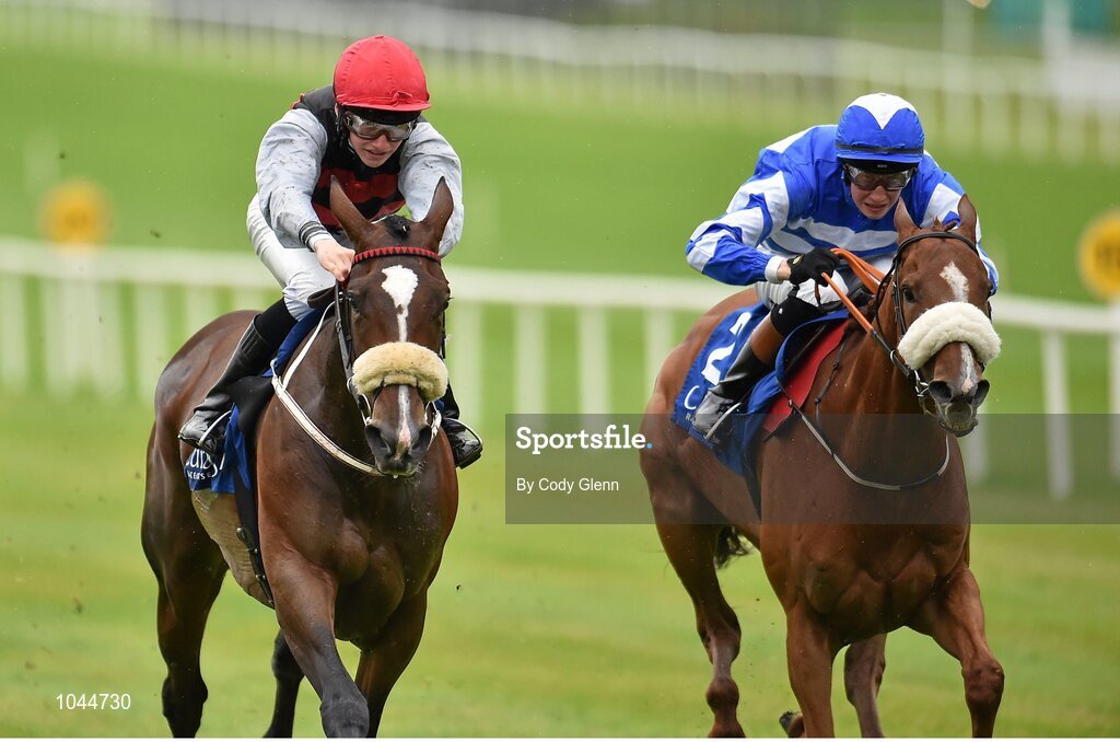 23 August 2015; Cailin Mor, left, with Sean Corby up, race alongside Chillie Billie, with Ross Coakley up, who finished second, on their way to winning the Luke & Nellie Comer Apprentice Handicap. Horse Racing from the Curragh. Curragh, Co. Kildare. Picture credit: Cody Glenn / SPORTSFILE