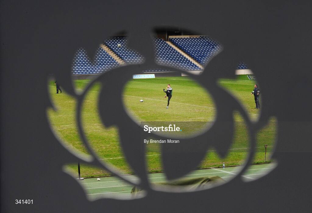 13 March 2009; Through the emblem of the Scottish Rugby Union, out-half Ronan O'Gara practices his kicking, watched by kicking coach Mark Tainton, right, during their Captain's Run ahead of their RBS Six Nations Championship game against Scotland on Saturday. Murrayfield Stadium, Edinburgh, Scotland. Picture credit: Brendan Moran / SPORTSFILE
