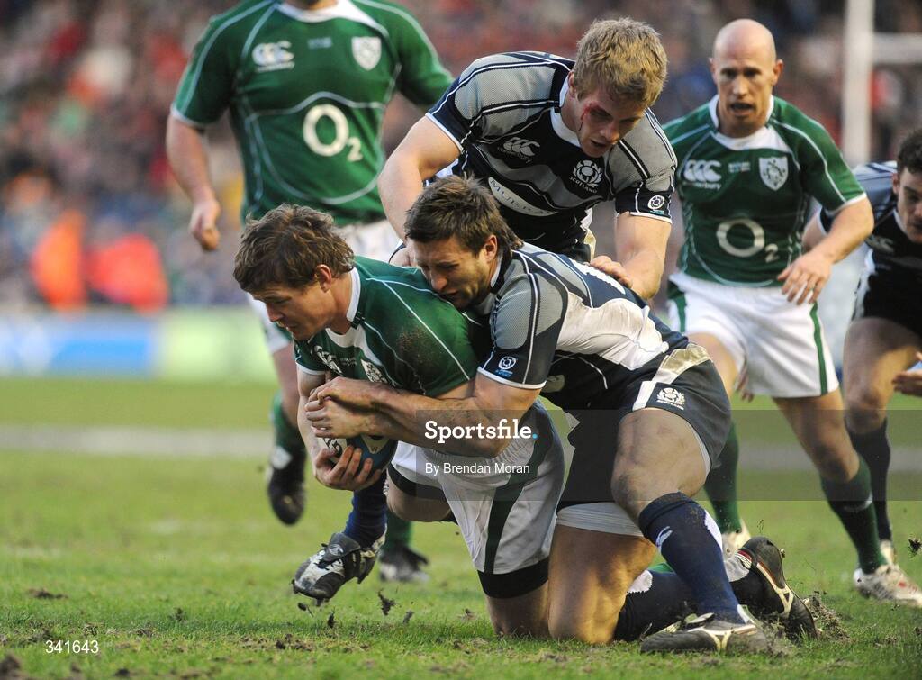14 March 2009; Brian O'Driscoll, Ireland, is tackled by Simon Danielli and Simon Taylor, top, Scotland. RBS Six Nations Championship, Scotland v Ireland, Murrayfield Stadium, Edinburgh, Scotland. Picture credit: Brendan Moran / SPORTSFILE