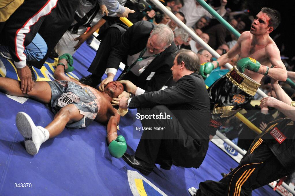 21 March 2009; Bernard Dunne looks on as Ricardo Cordoba receives medical attention after being knocked down in the eleventh round during the WBA World Super Bantamweight title. Hunky Dory World Title Fight Night, Bernard Dunne v Ricardo Cordoba, The O2, Dublin. Picture credit: David Maher / SPORTSFILE