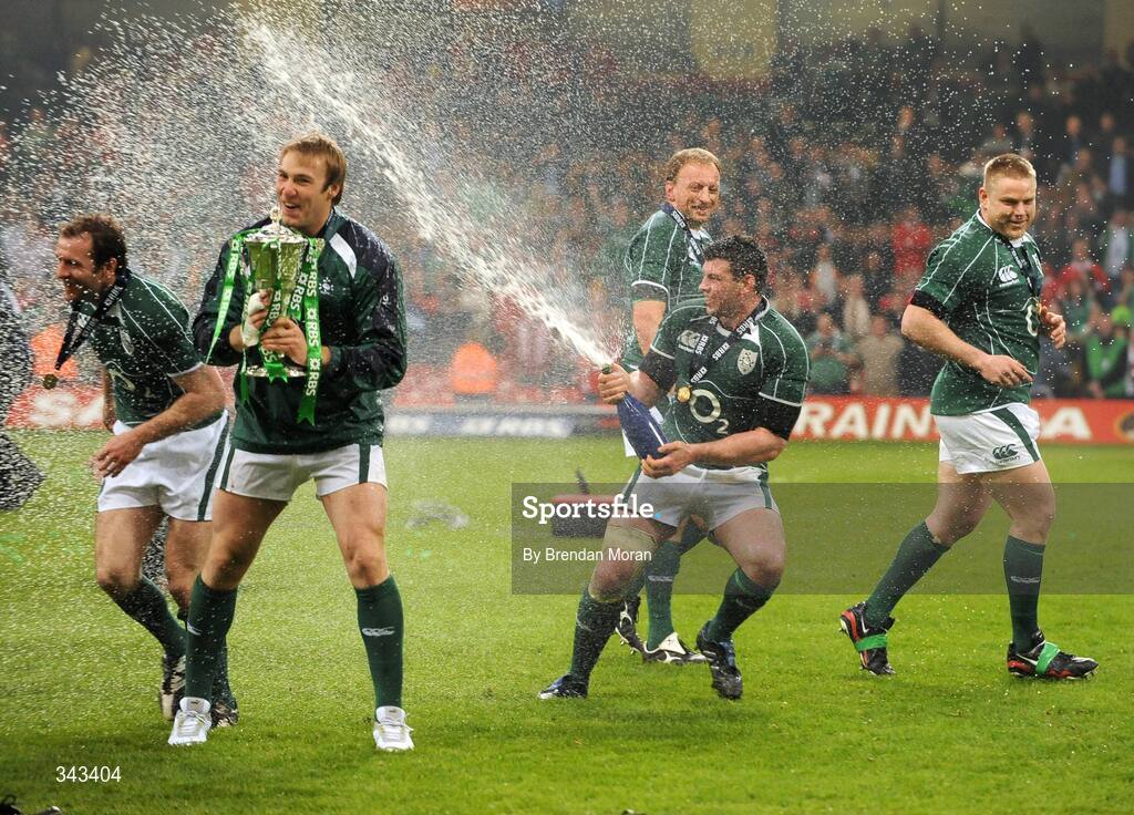 21 March 2009; Ireland's Denis Leamy sprays champagne on team-mates Geordan Murphy and Stephen Ferris, holding the RBS Six Nations trophy, watched by Mick O'Driscoll and Tom Court. RBS Six Nations Championship, Wales v Ireland, Millennium Stadium, Cardiff, Wales. Picture credit: Brendan Moran / SPORTSFILE
