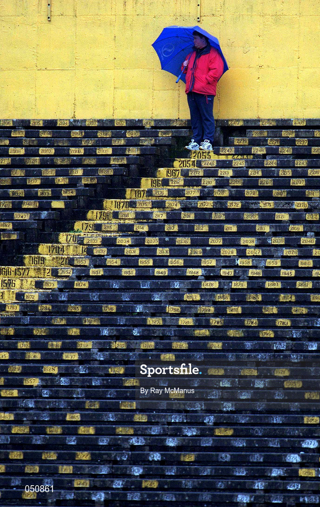 30 October 2000; A supporter watches the game from the stands during the AIB Munster Club Hurling Championship match between Patrickswell and Toomevara at Semple Stadium in Thurles, Tipperary. Photo by Ray McManus/Sportsfile
