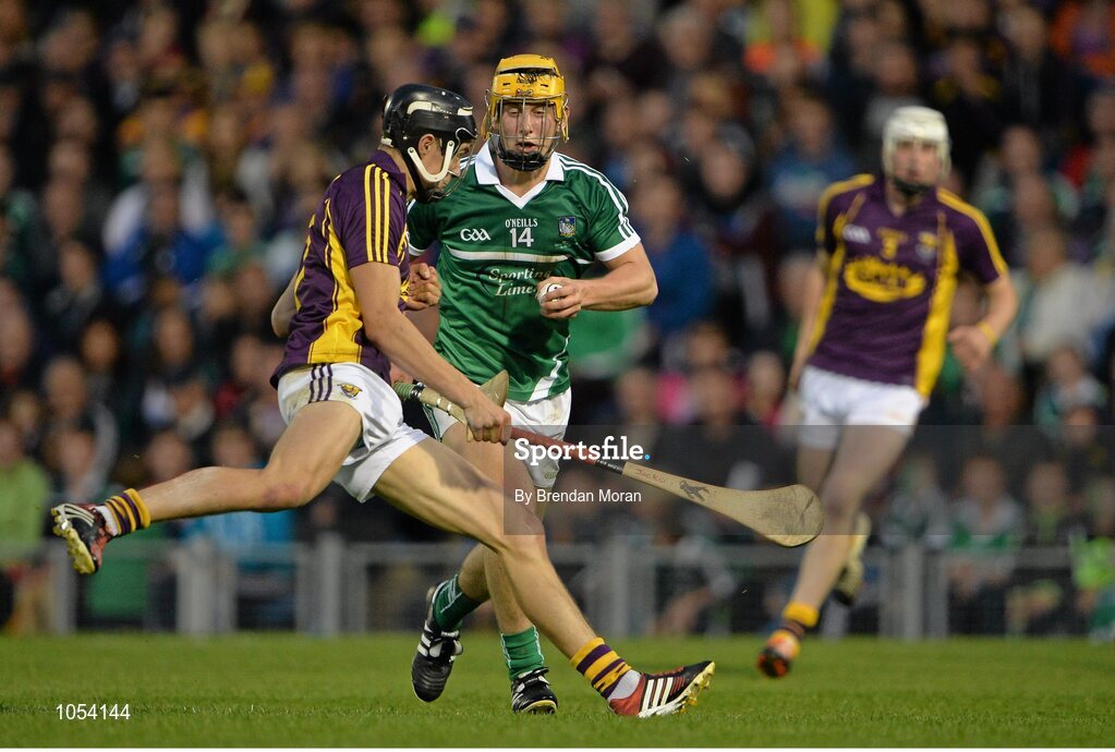 12 September 2015; Tom Morrissey, Limerick, is shouldered by Jack O'Connor, Wexford. Bord Gais Energy GAA Hurling All-Ireland U21 Championship Final, Limerick v Wexford, Semple Stadium, Thurles, Co. Tipperary. Picture credit: Brendan Moran / SPORTSFILE