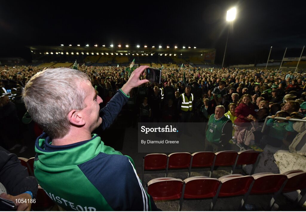 12 September 2015; Limerick manager John Kiely savours the moment by recording some of the large crowd of Limerick supporters on the pitch after the game. Bord Gais Energy GAA Hurling All-Ireland U21 Championship Final, Limerick v Wexford, Semple Stadium, Thurles, Co. Tipperary. Picture credit: Diarmuid Greene / SPORTSFILE