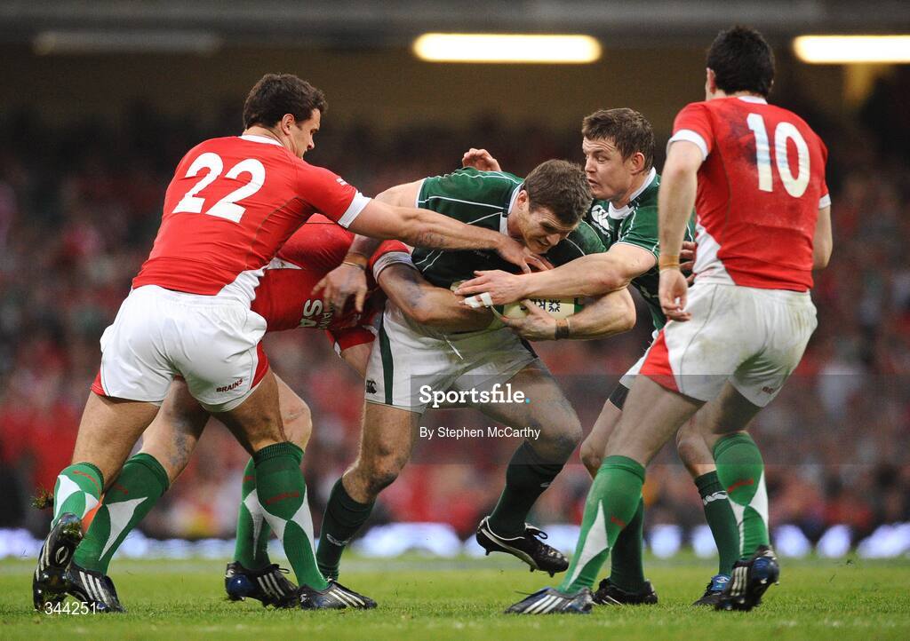 21 March 2009; Gordon D'Arcy, Ireland, supported by Brian O'Driscoll is tackled by Jamie Roberts, 22, Tom Shanklin and Stephen Jones, 10, Wales. RBS Six Nations Championship, Wales v Ireland, Millennium Stadium, Cardiff, Wales. Picture credit: Stephen McCarthy / SPORTSFILE