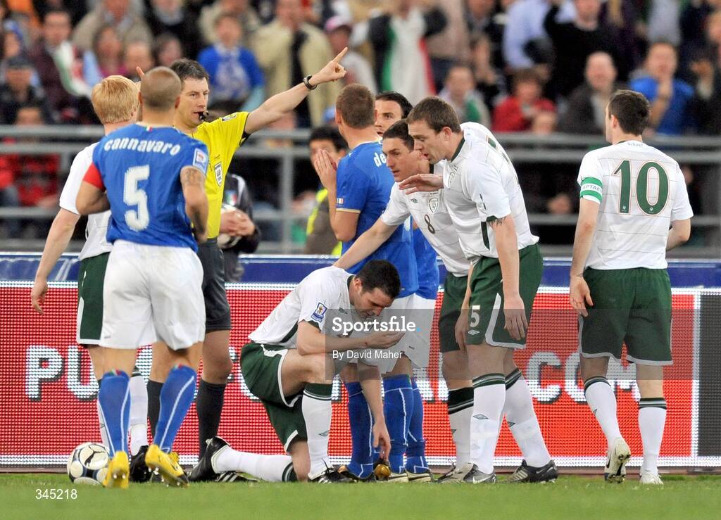 1 April 2009; Republic of Ireland's John O'Shea lies injured as referee Wolfgang Stark sends off Giampaolo Pazzini, Italy. 2010 FIFA World Cup Qualifier, Italy v Republic of Ireland, San Nicola Stadium, Bari, Italy. Picture credit: David Maher / SPORTSFILE