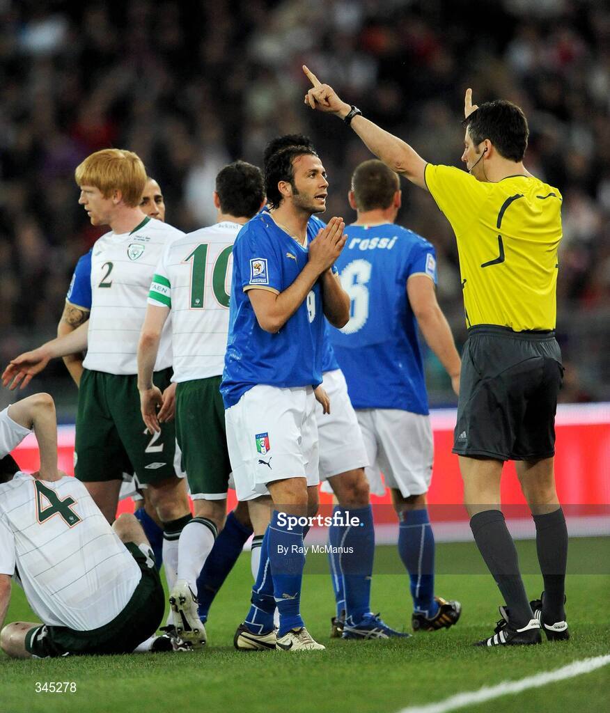 1 April 2009; Giampaolo Pazzini, Italy, pleads with referee Wolfgang Stark before being shown a red card, as John O'Shea, no.4, Republic of Ireland, lies injured on the pitch. 2010 FIFA World Cup Qualifier, Italy v Republic of Ireland, San Nicola Stadium, Bari, Italy. Picture credit: Ray McManus / SPORTSFILE