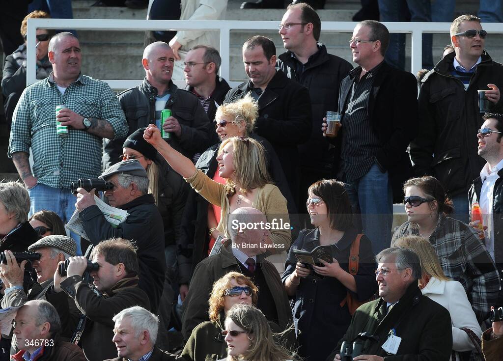 12 April 2009; A race fan cheers on her horse during the Ryan's Cleaning Events Specialist Beginners Steeplechase. Fairyhouse, Co. Meath. Picture credit: Brian Lawless / SPORTSFILE *** Local Caption ***