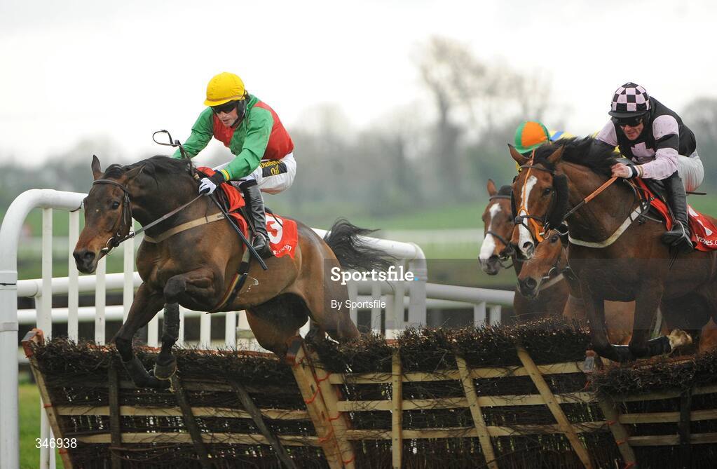 13 April 2009; Coolcashin, with Keith Clarke up, jumps the last on the way to wining the Ladbrokes.com Hurdle ahead of second place Essex, right, with Davy Russell up. Fairyhouse Racecourse, Co. Meath. Photo by Sportsfile