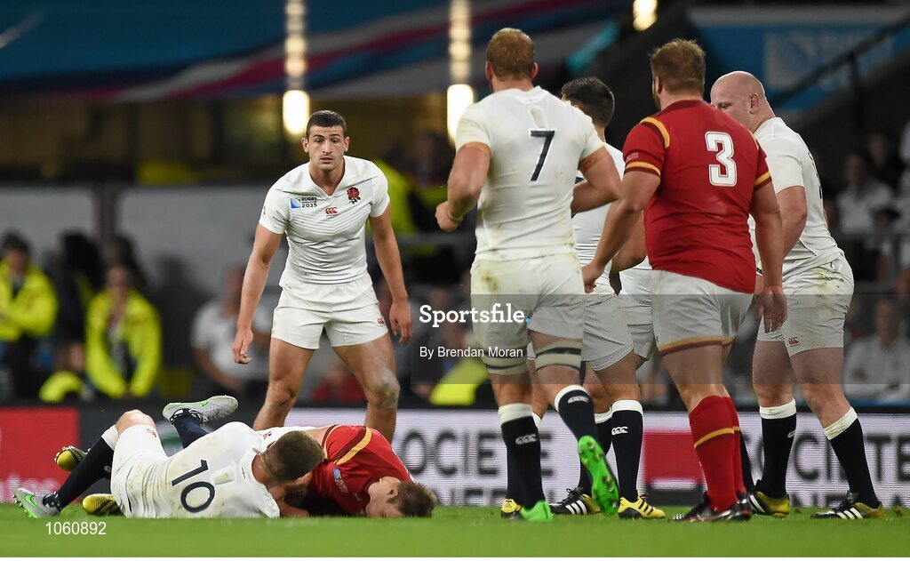 26 September 2015; Liam Williams, Wales, bangs his head after a tackle by Owen Farrell, England. 2015 Rugby World Cup, Pool A, England v Wales, Twickenham Stadium, London, England. Picture credit: Brendan Moran / SPORTSFILE