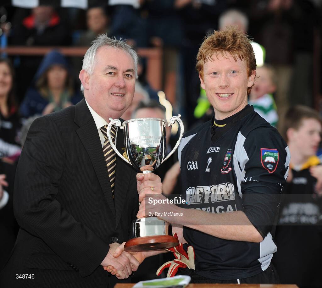 25 April 2009; The Sligo captain Charles Harrison is presented with the trophy by GAA President Christy Cooney.  Allianz GAA National Football League, Division 4 Final, Antrim v Sligo, Pearse Park, Longford. Picture credit: Ray McManus / SPORTSFILE