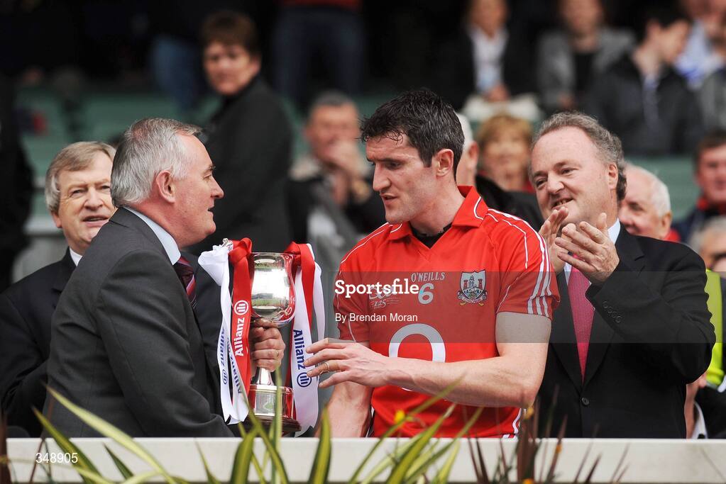 26 April 2009; New President of the GAA and Corkman Christy Cooney presents the Division 2 trophy to Cork captain Graham Canty, in the company of Paraic Duffy, left, Ard Atiurthoir of the GAA and Brendan Murphy, CEO, Allianz Ireland. Allianz GAA National Football League, Division 2 Final, Cork v Monaghan, Croke Park, Dublin. Picture credit: Brendan Moran / SPORTSFILE