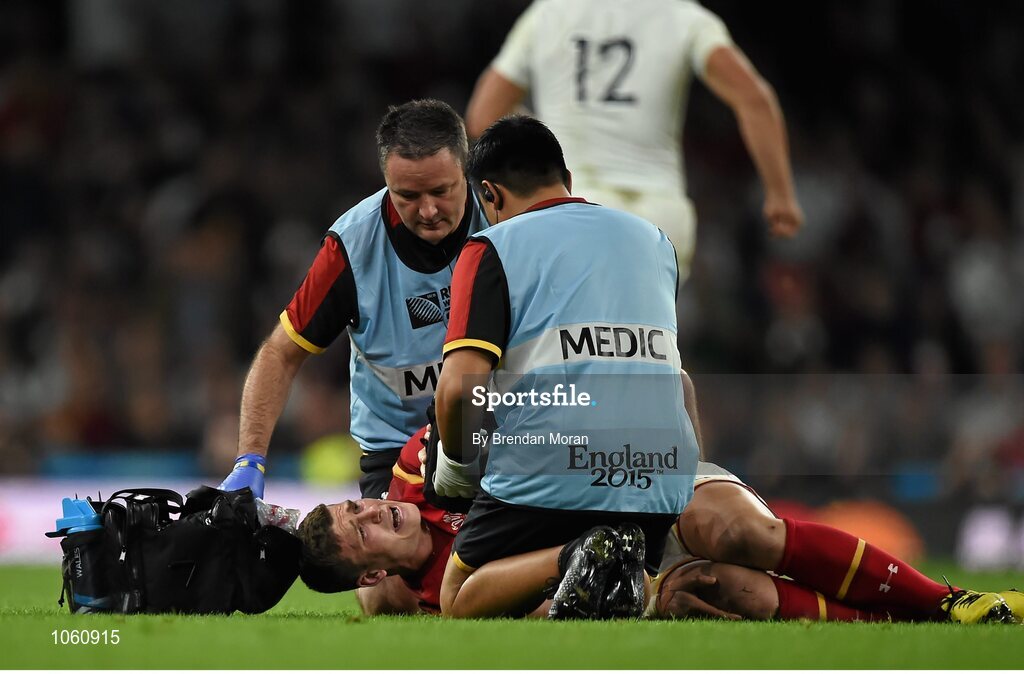 26 September 2015; Scott Williams, Wales, is attended to by medical personnel as he lies injured before being taken off the pitch on a stretcher. 2015 Rugby World Cup, Pool A, England v Wales, Twickenham Stadium, London, England. Picture credit: Brendan Moran / SPORTSFILE