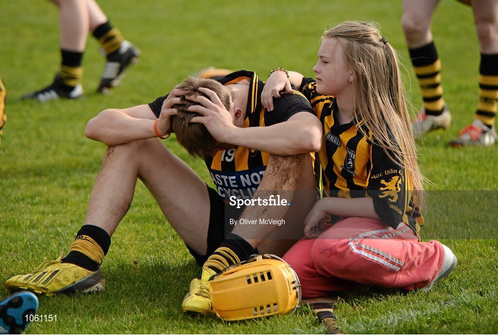 27 September 2015; A dejected Caolan McCaughan, Ballycastle McQuillan, is consoled by a young fan after the game. Antrim Senior Championship Hurling Final, Ruairi Og Cushendall v Ballycastle McQuillan, Dunloy GAA Club, Dunloy, Co. Antrim. Picture credit: Oliver McVeigh / SPORTSFILE