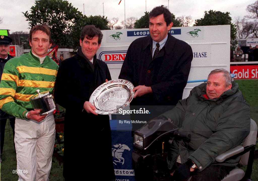 26 December 2000; Mr. Flor Healy, General manager, Henry Denny and Son, second from right, presents a perpetual trophy to the winning owner, JP McManus, second from left, in the company of winning jockey Tom Rudd and Winning trainer Michael O'Brien after Knife Edge won The Denny Gold Medal Novice Steeplechase during day one of the Christmas Festival at Leopardstown Racecourse in Dublin. Photo by Ray McManus/Sportsfile