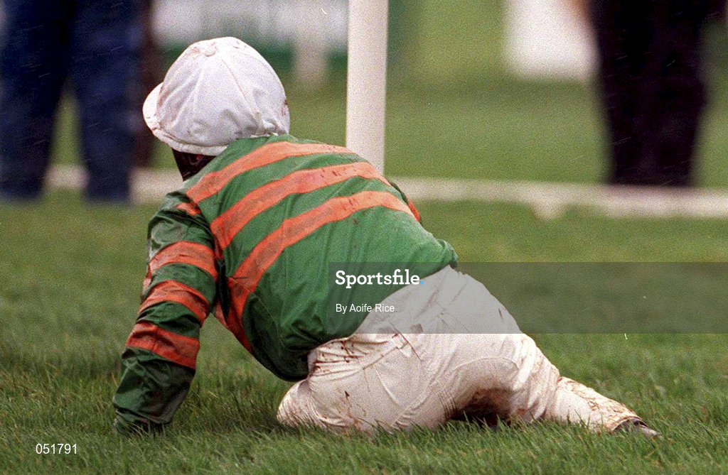 31 December 2000; Jockey Charlie Swan on the ground after falling from Istabraq in the The AIB Agri Business December Festival Hurdle during day three of the Christmas Festival at Leopardstown Racecourse in Dublin. Photo by Aoife Rice/Sportsfile