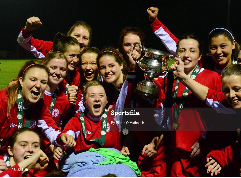 30 September 2015; Shelbourne U18 LFC players gather around their captain Caolan Lynch Carroll lifts the cup while on an ambulance trolley after picking up an injury during the first half. FAI Umbro Women’s Intermediate Cup Final, St Catherine’s LFC v Shelbourne U18 LFC. Frank Cooke Park, Glasnevin, Dublin. Picture credit: Piaras Ó Mídheach / SPORTSFILE