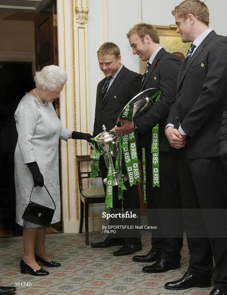 7 May 2009; Her Majesty the Queen is shown the RBS Six Nations trophy by Tom Court and the Triple Crown trophy by Stephen Ferris, in the company of Jamie Heaslip, at a civic reception for Ireland Rugby Squad on the second day of her visit to Northern Ireland. Hillsborough Castle, Hillsborough, Co. Down. Picture credit: SPORTSFILE/ Niall Carson / PA POOL *** Local Caption ***