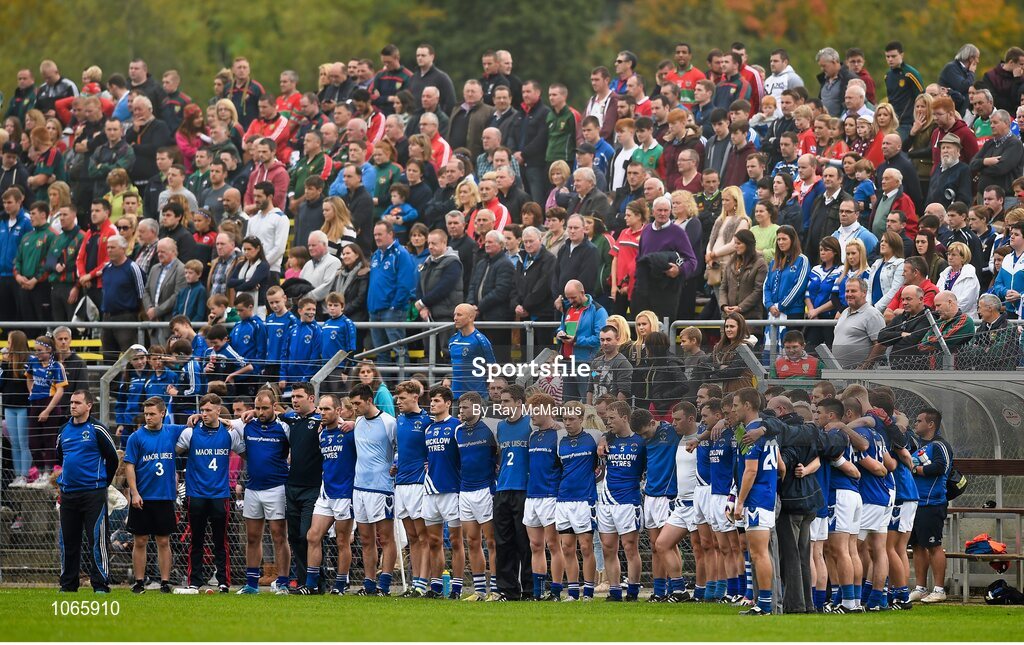 11 October 2015; The St. Patrick's players stand during a minutes silence in memory of those who perished in the Carrickmines fire. Renault Ireland Wicklow County Senior Football Championship Final, Rathnew v St Patrick's. County Grounds, Aughrim, Co. Wicklow. Picture credit: Ray McManus / SPORTSFILE