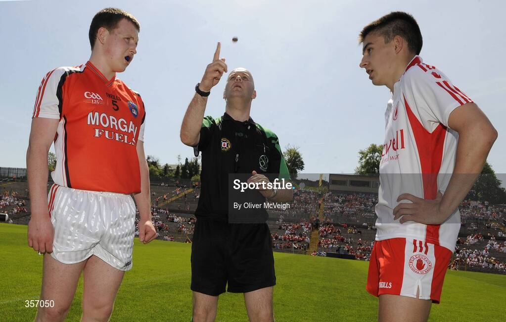 31 May 2009; Armagh captain Declan McKenna and Tyrone captain Sean Warnock watch as referee Fergal Cleary makes the toss before the game. Ulster GAA Football Minor Championship, Tyrone v Armagh, St. Tiernach's Park, Clones, Co. Monaghan. Picture credit: Oliver McVeigh / SPORTSFILE
