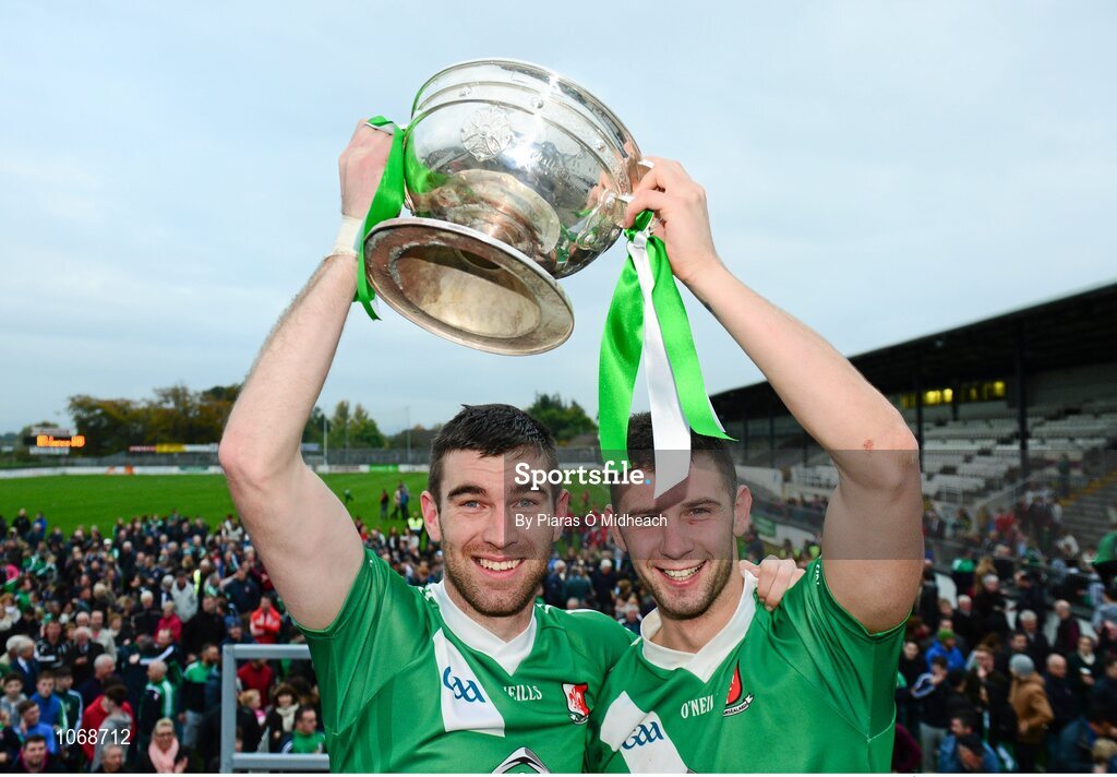 18 October 2015; Sarsfields Seán Campbell, left, and Matty Byrne, lift the the Dermot Bourke Cup after the game. Kildare County Senior Football Championship Final, Athy v Sarsfields. St Conleth's Park, Newbridge, Co. Kildare. Picture credit: Piaras Ó Mídheach / SPORTSFILE