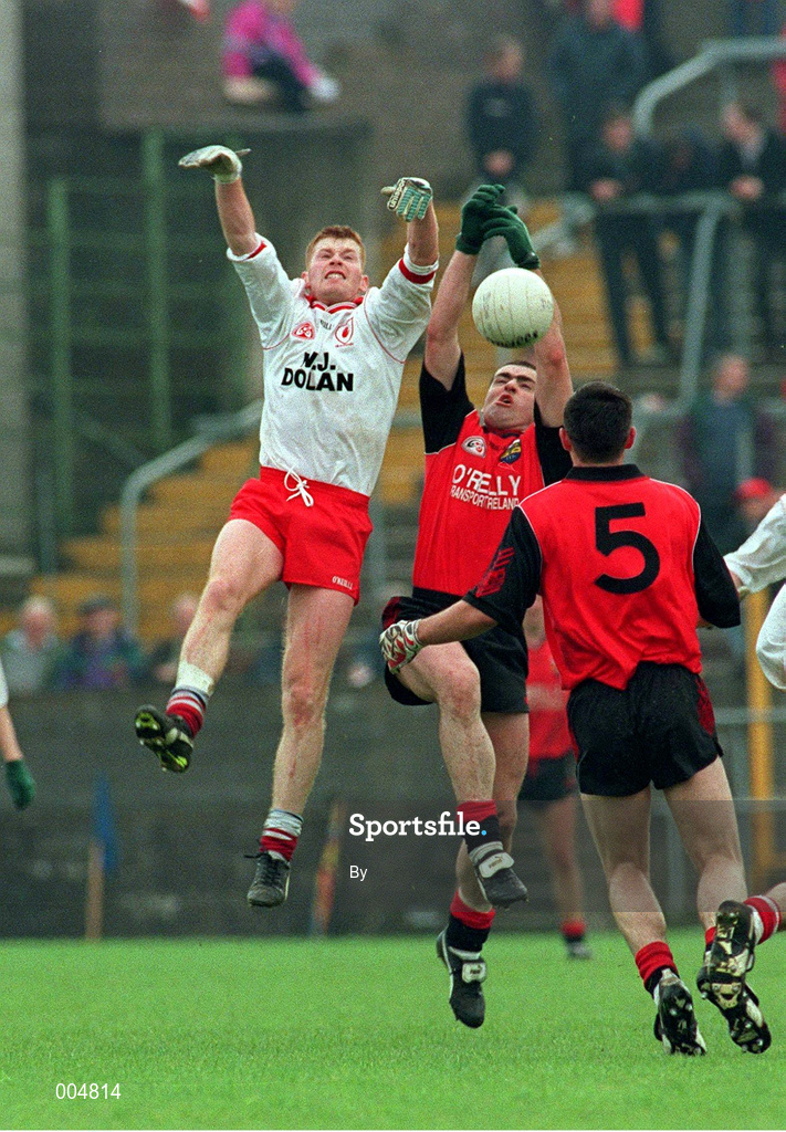 18 May 1997. Down's Greg McCartan goes up for the ball with Tyrone's Jody Gormley as Down's Daniel Flynn (5) looks on. Bank of Ireland Ulster Football Championship, Tyrone v Down, Clones. Picture Credit David Maher/SPORTSFILE.