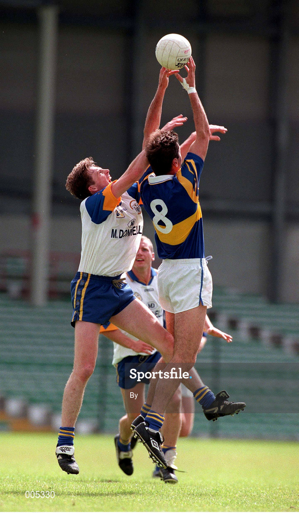 28 June 1998. Tipperary's Derry Foley (8) in action against Clare's Joe Considine. Tipperary v Clare. Munster Football Championship, Gaelic Grounds. Picture Credit: Brendan Moran/SPORTSFILE.