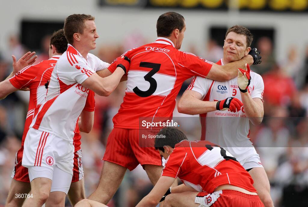 21 June 2009; Sean Lockhart, Derry, strikes Enda McGinley, Tyrone, during a row in the 2nd half. GAA Football Ulster Senior Championship Semi-Final, Tyrone v Derry, Casement Park, Belfast, Co. Antrim. Photo by Sportsfile