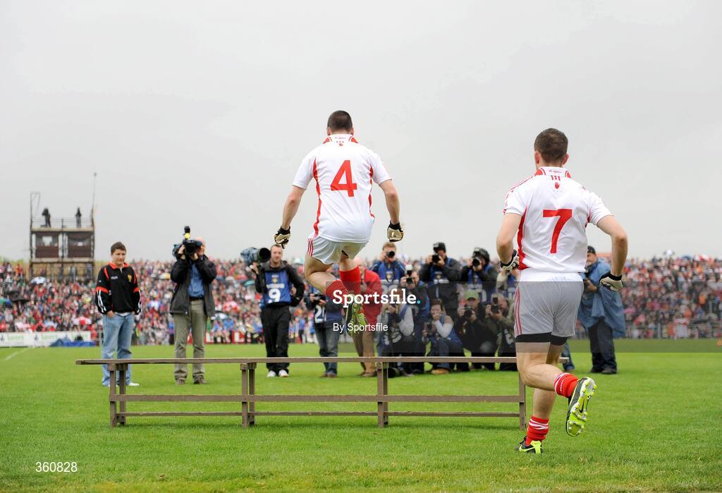 21 June 2009; Tyrone's Ryan McMenamin jumps the bench for the team picture, followed by team-mate Philip Jordan. GAA Football Ulster Senior Championship Semi-Final, Tyrone v Derry, Casement Park, Belfast, Co. Antrim. Photo by Sportsfile