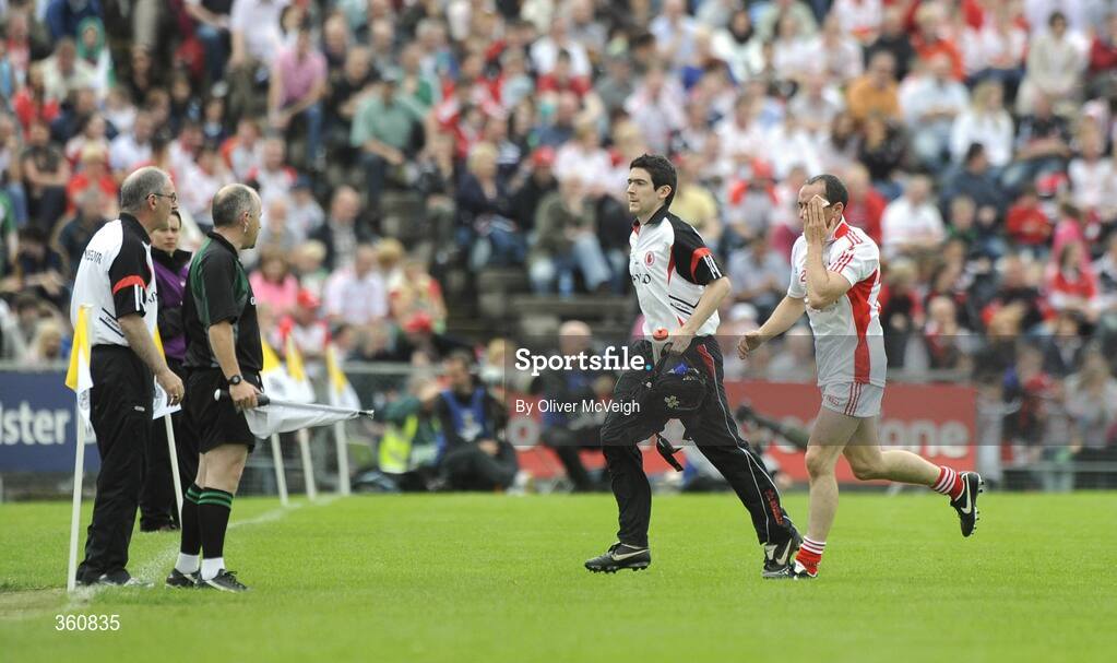 21 June 2009; Brian Dooher, Tyrone, goes off with Tyrone Physio, Michael Harte, as Mickey Harte, keeps an eye on proceedings. GAA Football Ulster Senior Championship Semi-Final, Tyrone v Derry, Casement Park, Belfast, Co. Antrim. Picture credit: Oliver McVeigh / SPORTSFILE