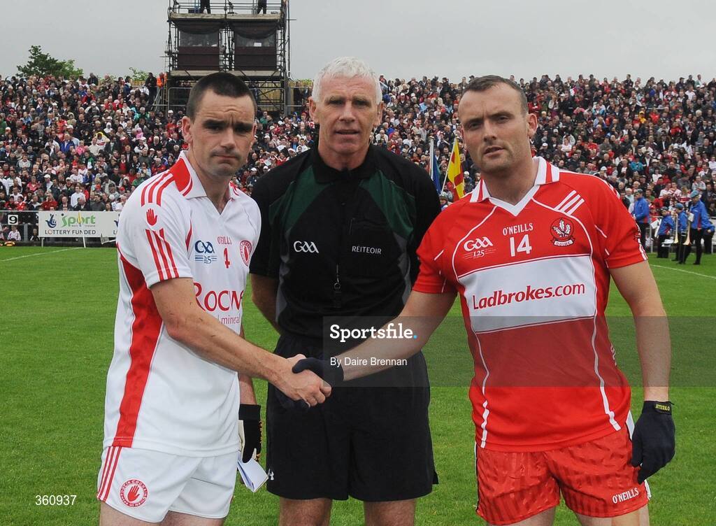 21 June 2009; Tyrone Captain Ryan McMenamin shakes hands with Derry Captain Paddy Bradley, while referee Gearoid O Conamha looks on. GAA Football Ulster Senior Championship Semi-Final, Tyrone v Derry, Casement Park, Belfast, Co. Antrim. Picture credit: Daire Brennan / SPORTSFILE