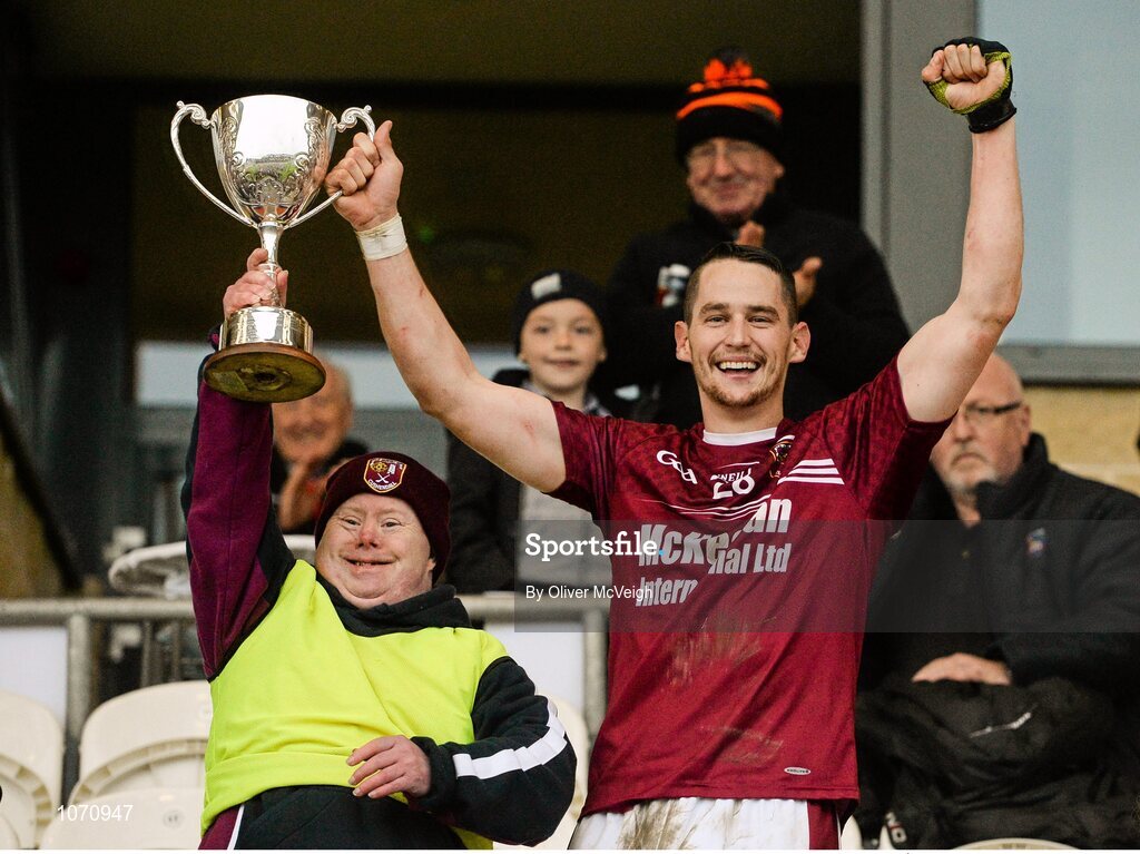 25 October 2015; Cushendall captain Sean Delargy along with team mascot John McKillop hold aloft the cup. AIB GAA Hurling Ulster GAA Senior Club Championship Final, Cushendall v Slaughtneil Ruairí Óg. Athletic Grounds, Armagh. Picture credit: Oliver McVeigh / SPORTSFILE