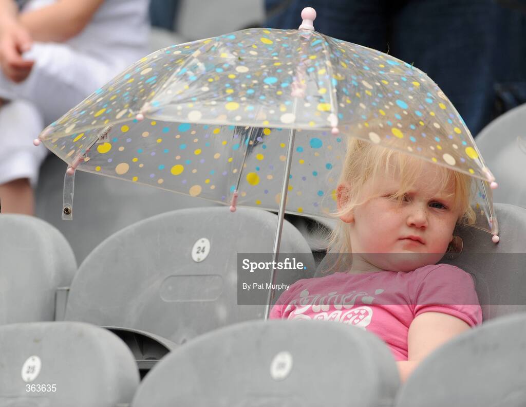 1 July 2009; Molly Fitzpatrick, age 5, from Callan, Co. Louth, shelters from the rain during the Leinster GAA Go Games ‘Play & Stay with the GAA’ activity day. Croke Park, Dublin. Picture credit: Pat Murphy / SPORTSFILE