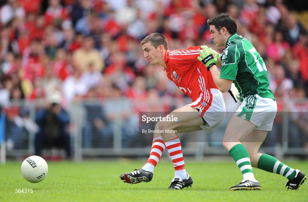 5 July 2009; Ger Collins, Limerick, is held back by Ray Carey, Cork. GAA Football Munster Senior Championship Final, Limerick v Cork, Pairc Ui Chaoimh, Cork. Picture credit: Brendan Moran / SPORTSFILE