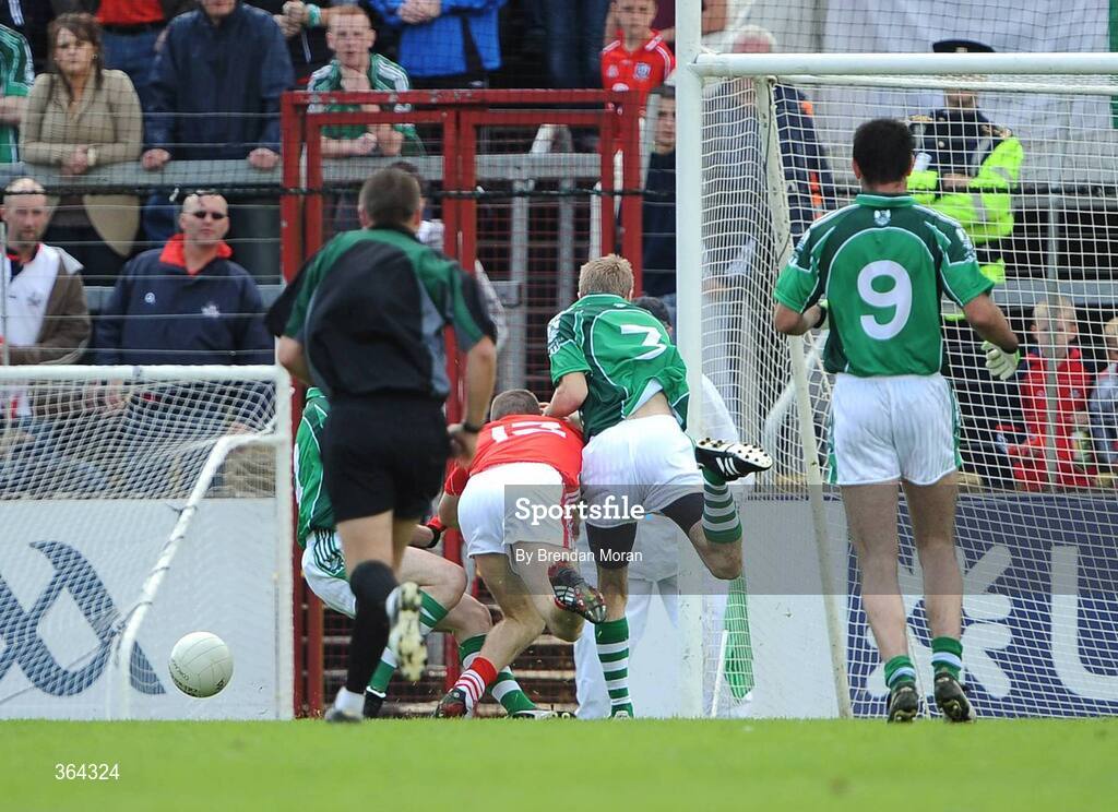 5 July 2009; Daniel Goulding, Cork, is tackled by Mark O'Riordan, left, and Shane Gallagher, Limerick, watched by referee Rory Hickey, which resulted in a penalty for Cork. GAA Football Munster Senior Championship Final, Limerick v Cork, Pairc Ui Chaoimh, Cork. Picture credit: Brendan Moran / SPORTSFILE