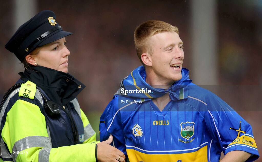 12 July 2009; A Tipperary fan is escorted by Gardai at the end of the match. GAA Hurling Munster Senior Championship Final, Tipperary v Waterford, Semple Stadium, Thurles, Co. Tipperary. Picture credit: Ray Ryan / SPORTSFILE