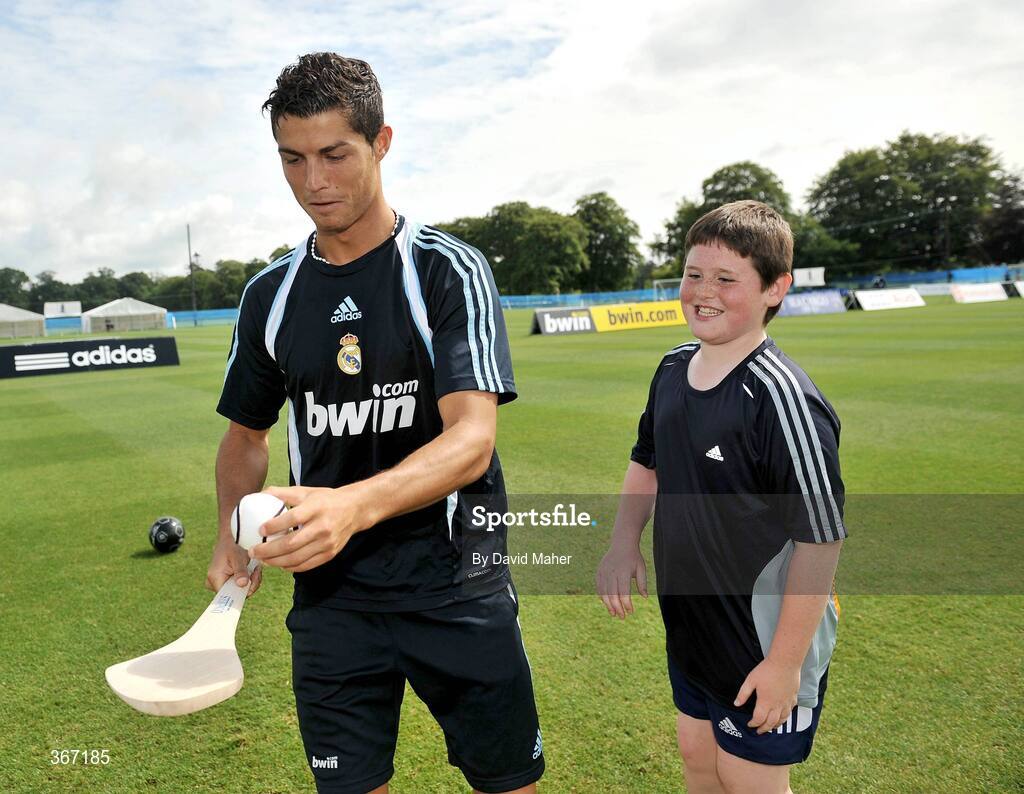 19 July 2009; Real Madrid's Cristiano Ronaldo shows his hurling skills to Ciaran McHugh, from Dublin, during a special training session run by adidas and Lifestyle Sports. Real Madrid pre-season squad training, Carton House, Maynooth, Co. Kildare. Picture credit: David Maher / SPORTSFILE