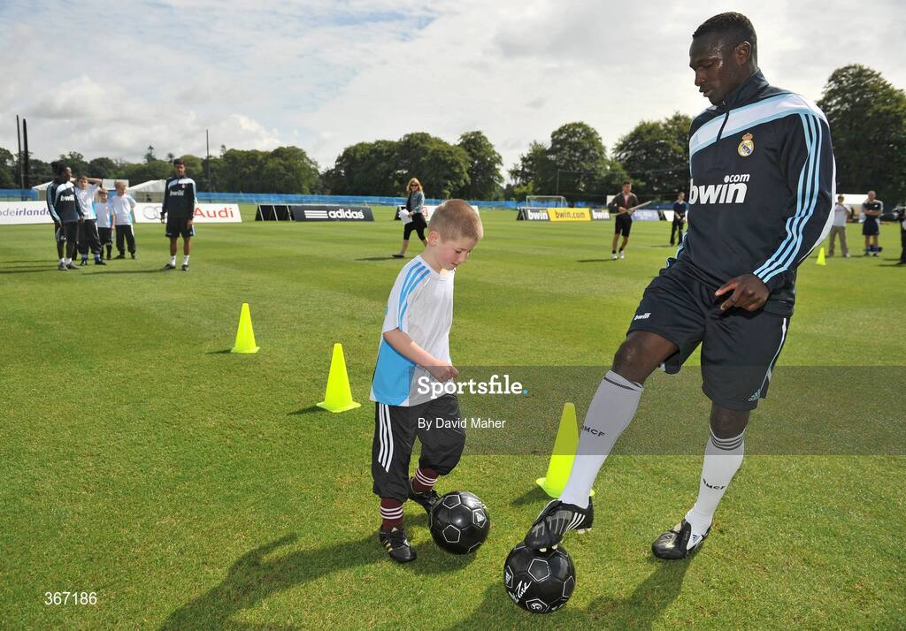19 July 2009; Sean Scully, from Naas, Co. Kildare, shows his skills to Real Madrid's Diarra, during a special training session run by adidas and Lifestyle Sports. Real Madrid pre-season squad training, Carton House, Maynooth, Co. Kildare. Picture credit: David Maher / SPORTSFILE