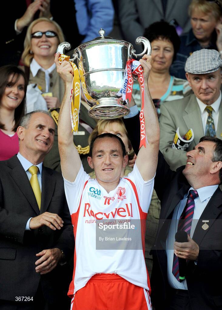 19 July 2009; Tyrone captain Brian Dooher lifts the cup as Dr. Martin McAleese, left, and Ulster GAA President Tom Daly keep a check on the lid. GAA Football Ulster Senior Championship Final, Tyrone v Antrim, St Tighearnach's Park, Clones, Co. Monaghan. Picture credit: Brian Lawless / SPORTSFILE