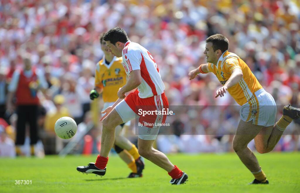 19 July 2009; Sean Cavanagh, Tyrone, goes past Antrim's Andy McClean on the way to score his side's first goal. GAA Football Ulster Senior Championship Final, Tyrone v Antrim, St Tighearnach's Park, Clones, Co. Monaghan. Picture credit: Brian Lawless / SPORTSFILE