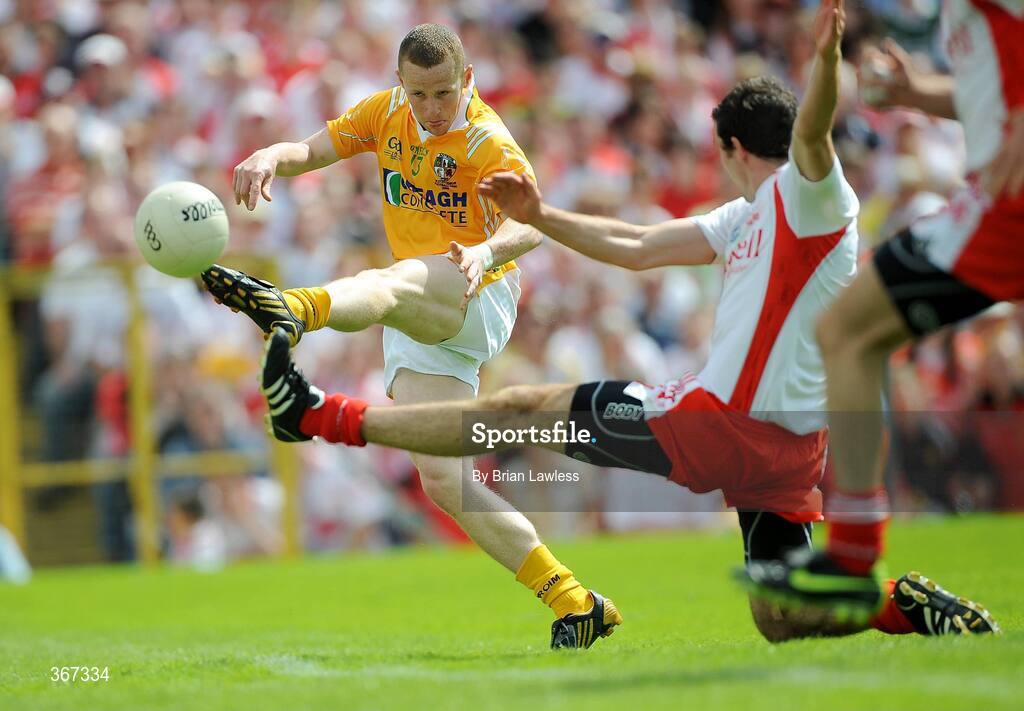19 July 2009; Paddy Cunningham, Antrim, has a shot on goal despite the attentions of Justin McMahon, Tyrone. GAA Football Ulster Senior Championship Final, Tyrone v Antrim, St Tighearnach's Park, Clones, Co. Monaghan. Picture credit: Brian Lawless / SPORTSFILE