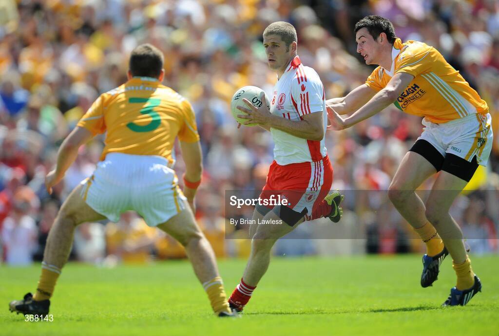 19 July 2009; Kevin Hughes, Tyrone, in action against Niall McKeever and Andy McClean, left, Antrim. GAA Football Ulster Senior Championship Final, Tyrone v Antrim, St Tighearnach's Park, Clones, Co. Monaghan. Picture credit: Brian Lawless / SPORTSFILE